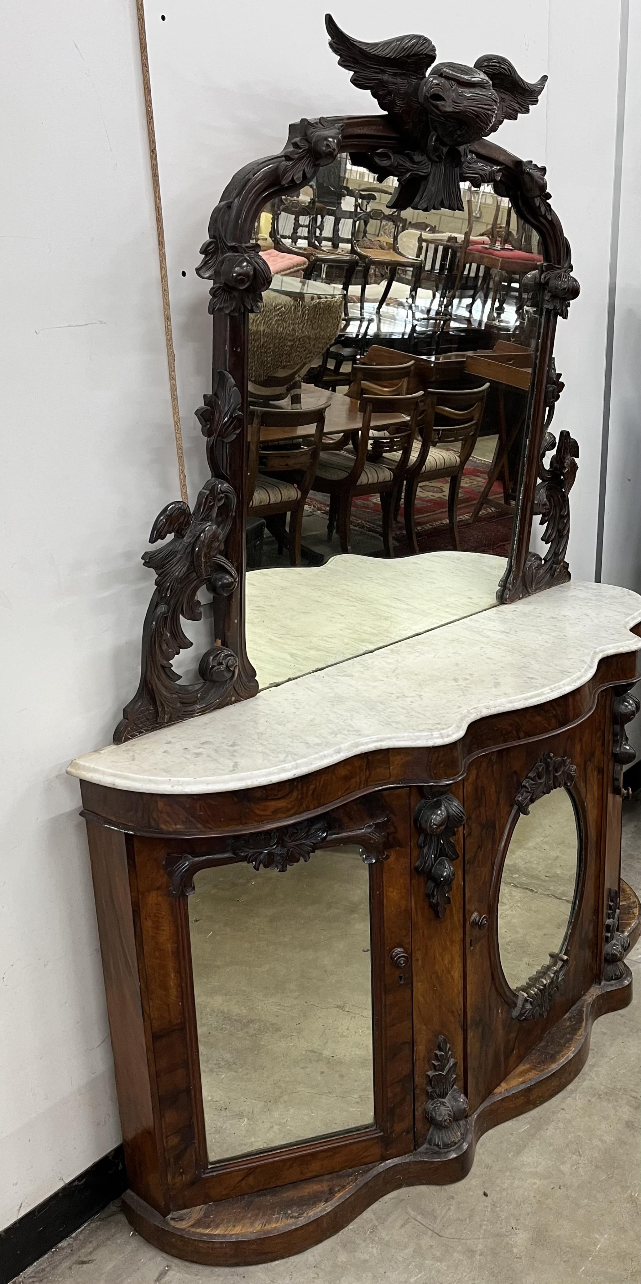 A Victorian walnut marble topped mirrored back credenza, mirror with eagle pediment, width 150cm, depth 43cm, height 125cm. Condition - poor to fair